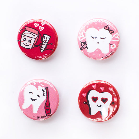 Set of four button magnets or pins featuring cute dental tooth characters in red and pink as part of a love-themed set.