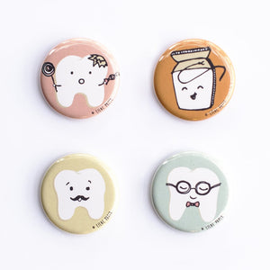 Set of four button magnets or pins featuring cute dental tooth characters in pastel colors. Hipster set of tooth characters by Lilac Paper.