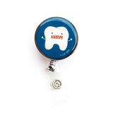 White tooth on a blue background with animated crazy face and large, open mouth full of teeth. Hyperdontia dental badge reel for dental professionals by Lilac Paper.