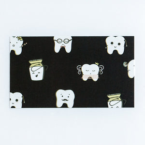 Black front side of appointment card with cute teeth characters all over the front.